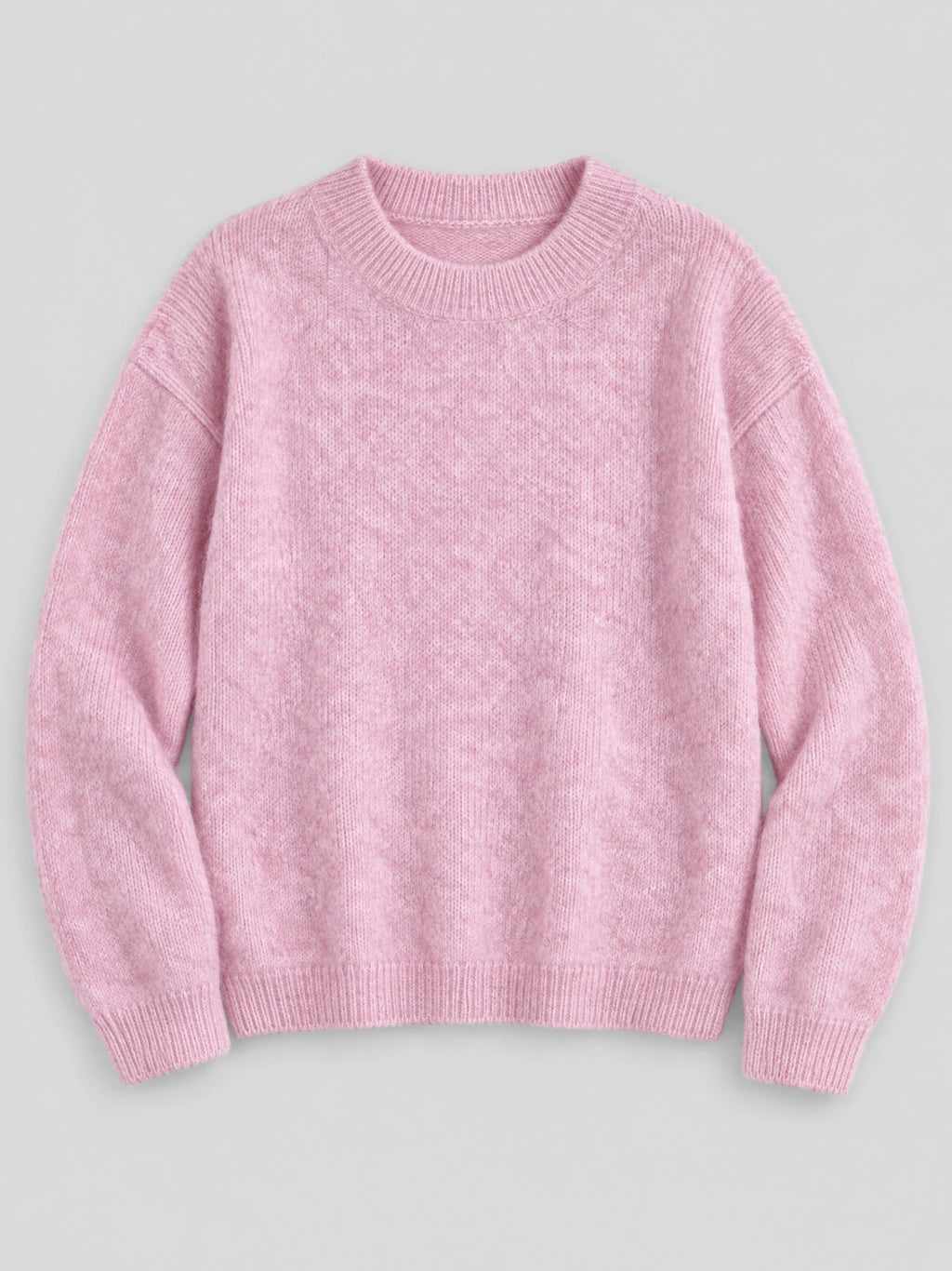 Pink women’s mohair winter sweater laid flat, featuring a ribbed crew neckline, cuffs, and hem.