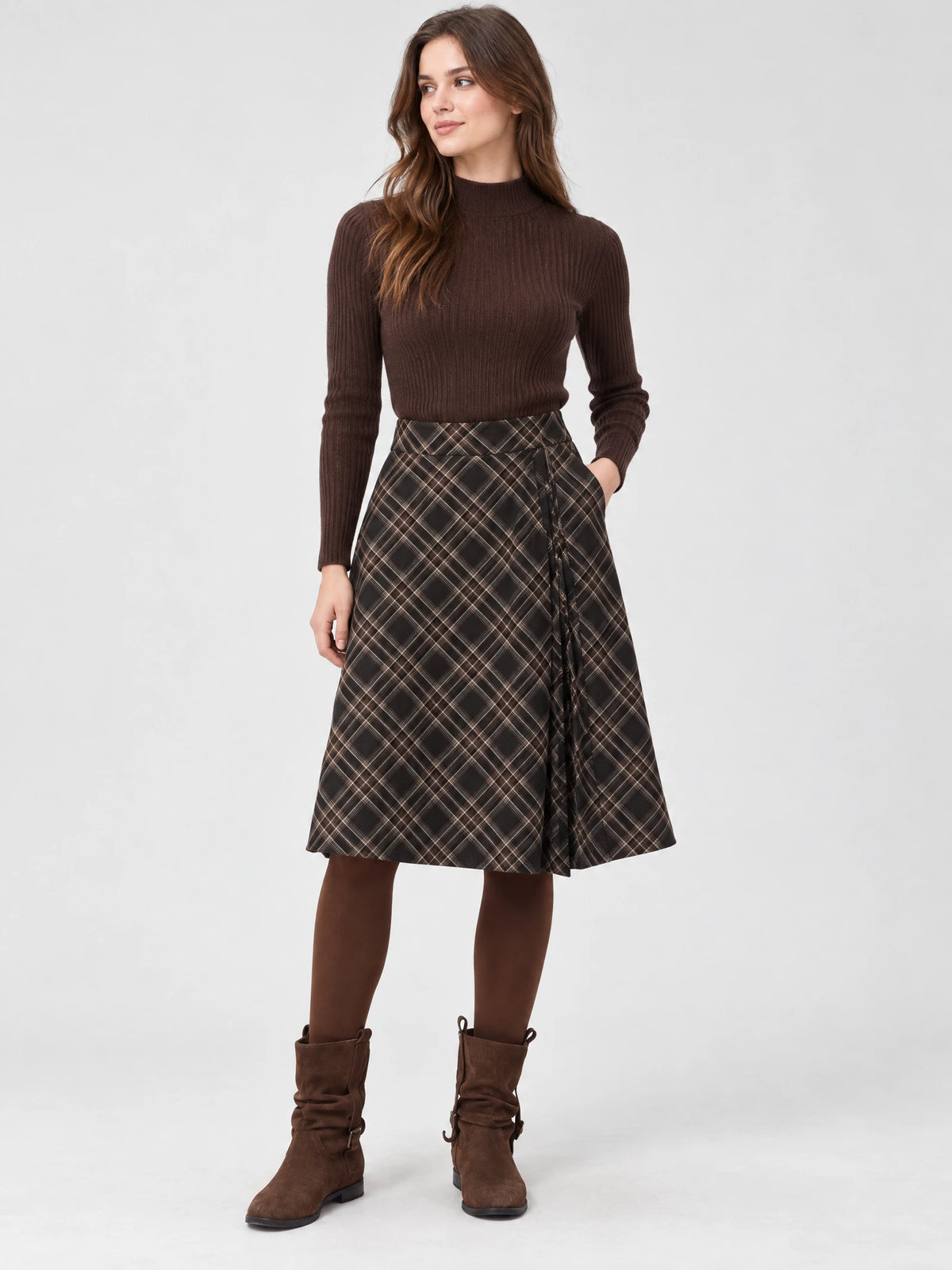 Front studio view of a model wearing a Brown checkered pleated A-line midi skirt with a side tie detail.
