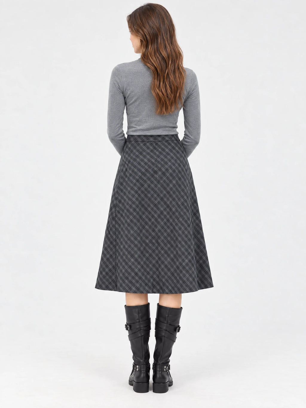 Rear studio view of a model wearing a Gray checkered Pleated A-line Skirt with a midi-length flared silhouette.