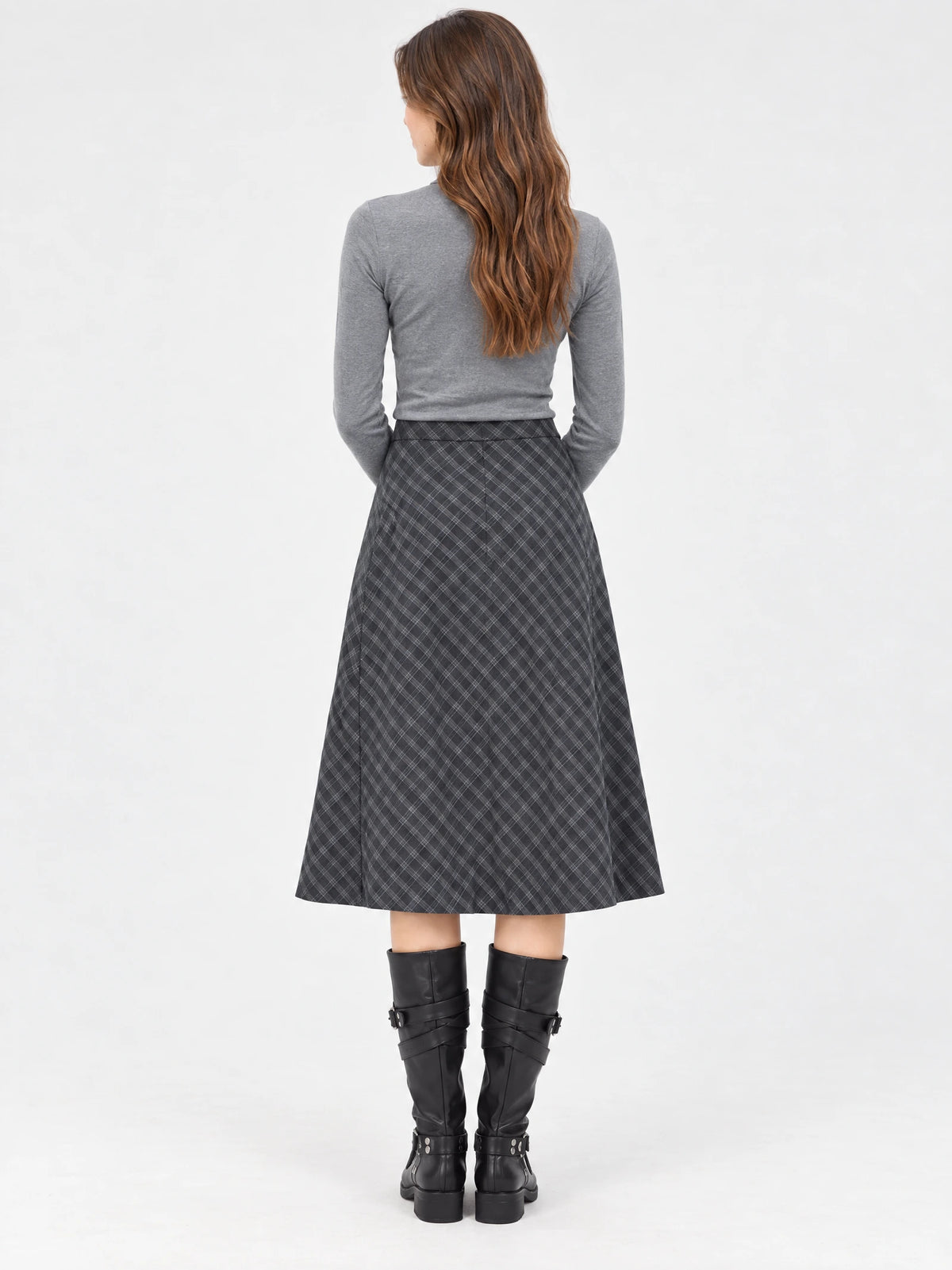 Rear studio view of a model wearing a Gray checkered Pleated A-line Skirt with a midi-length flared silhouette.