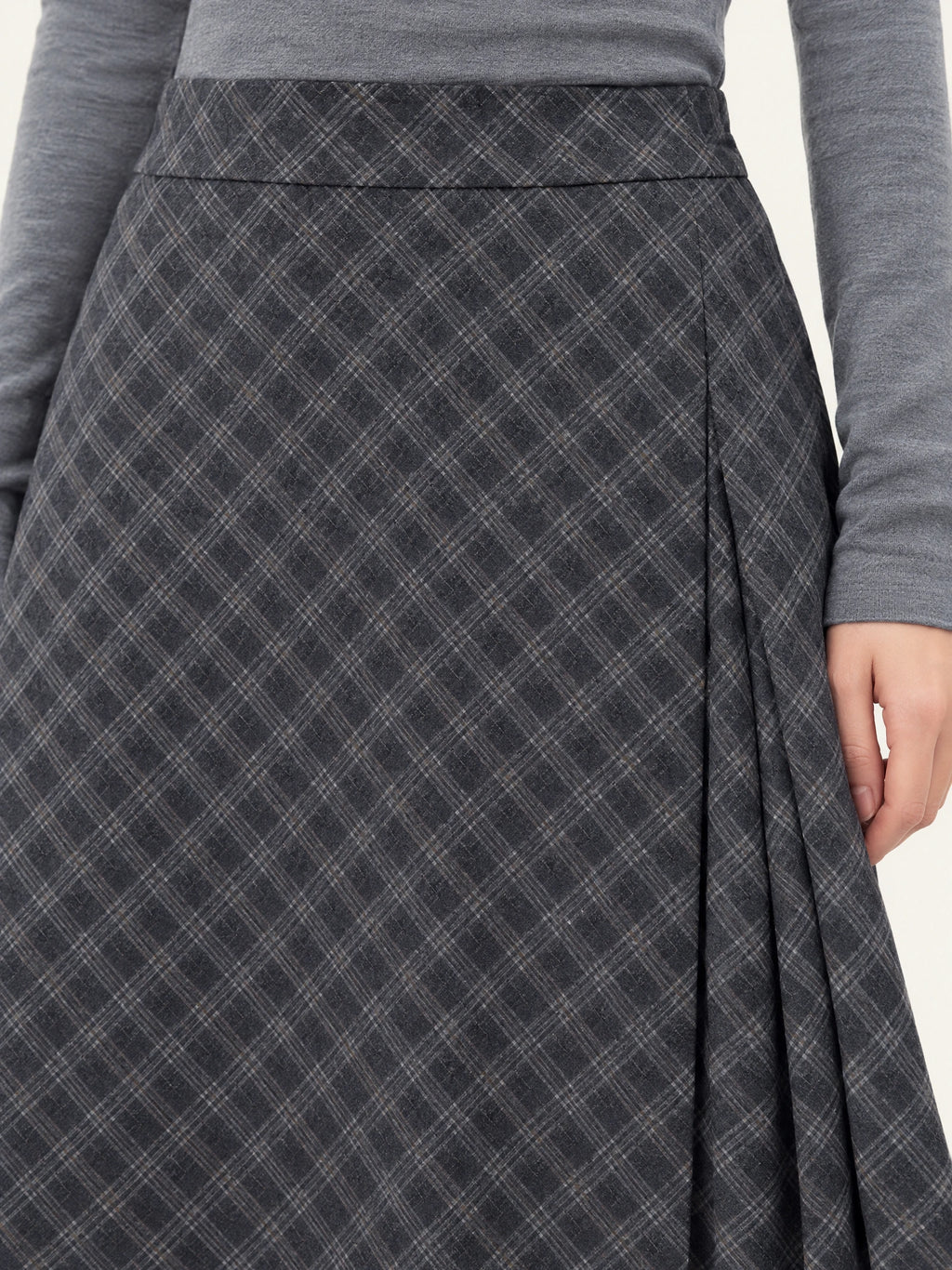 Close-up of the Gray cotton Pleated A-line Skirt showing its wide waistband, diagonal check pattern, and front pleats.