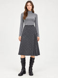Front studio view of a model wearing a Gray checkered Pleated A-line Skirt with a pleated side panel.
