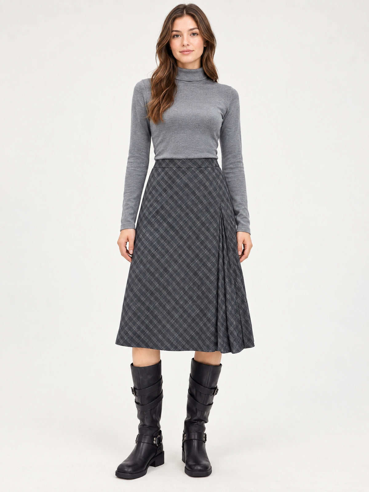 Front studio view of a model wearing a Gray checkered Pleated A-line Skirt with a pleated side panel.