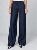 Front studio view of a model wearing Navy satin wide leg pants with a high elastic waist.