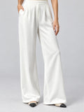 Front studio view of a model wearing White satin wide leg pants with a high waistband and side pockets.