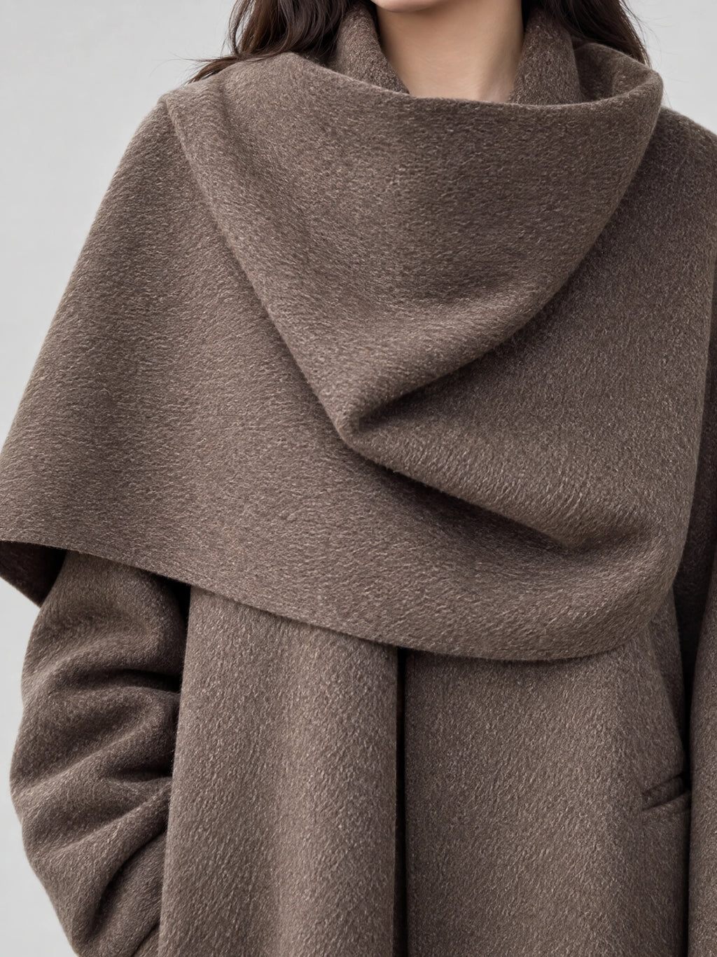 Close-up of the Brown Scarf Collar Wool Coat Women, highlighting its oversized draped scarf collar and textured wool fabric.