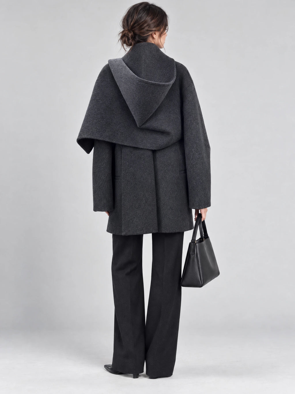 Back view of a woman wearing a Gray wool coat with a draped scarf-style collar and relaxed sleeves.