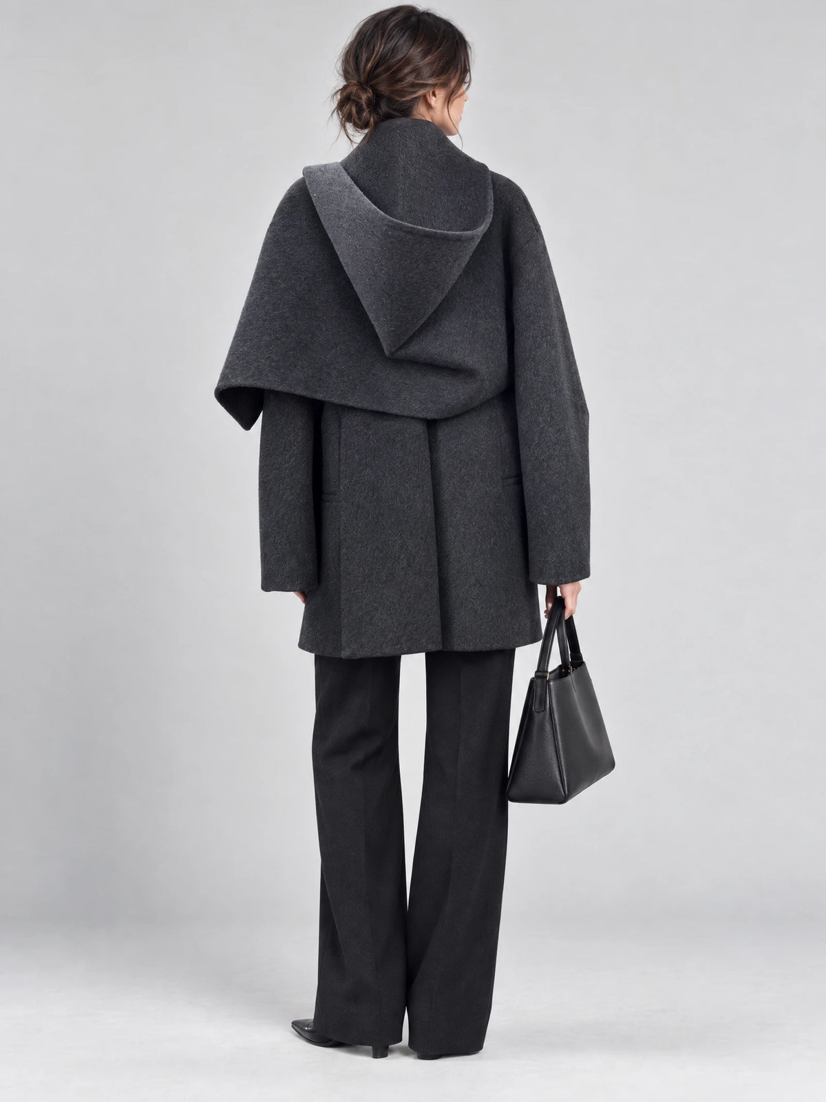 Back view of a woman wearing a Gray wool coat with a draped scarf-style collar and relaxed sleeves.