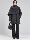 Front studio view of a model wearing a Gray wool coat with an oversized scarf collar and front pockets.