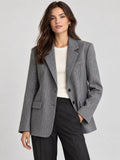Front studio view of a model wearing a Gray striped single-breasted blazer with notched lapels and flap pockets.