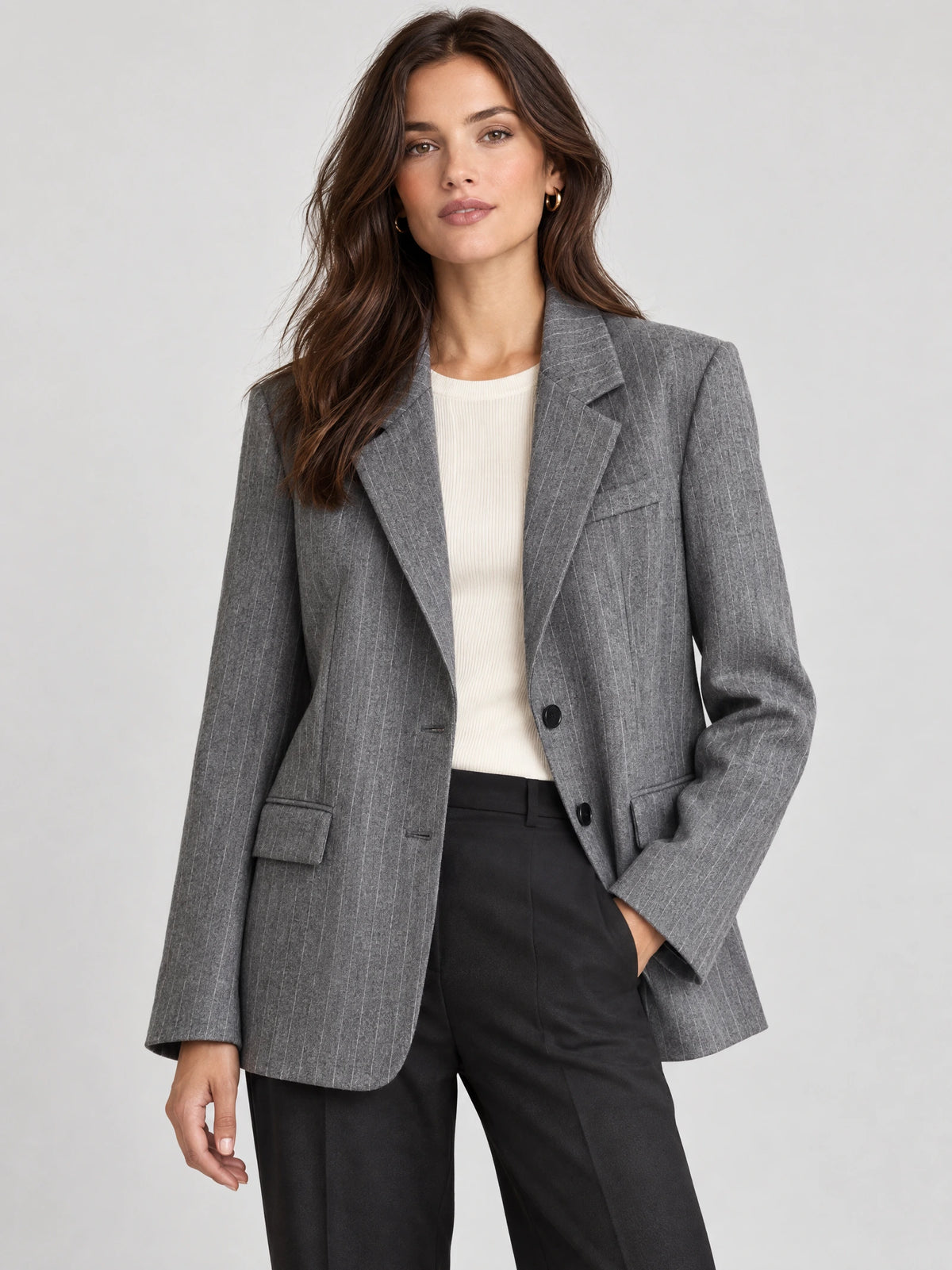 Front studio view of a model wearing a Gray striped single-breasted blazer with notched lapels and flap pockets.