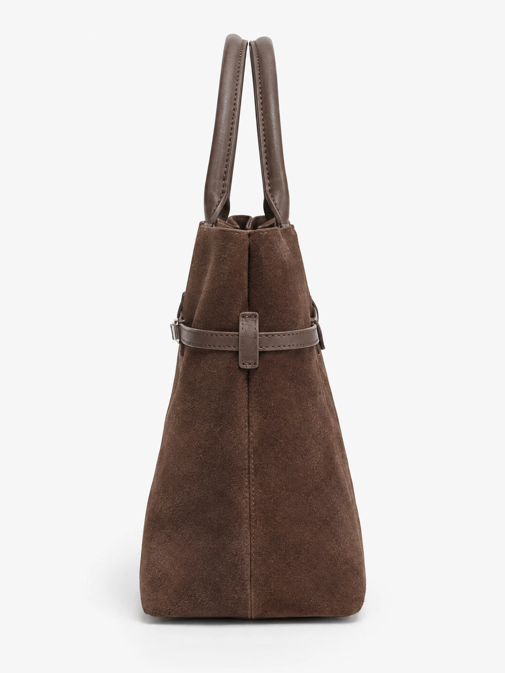 Brown suede leather tote bag, side view showing stitched handles, tapered side panel, and buckle strap detail.