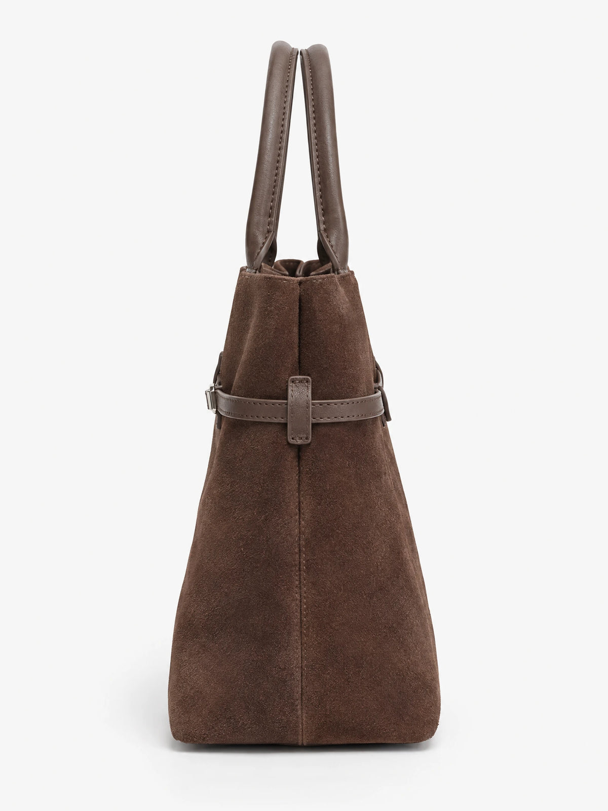 Brown suede leather tote bag, side view showing stitched handles, tapered side panel, and buckle strap detail.