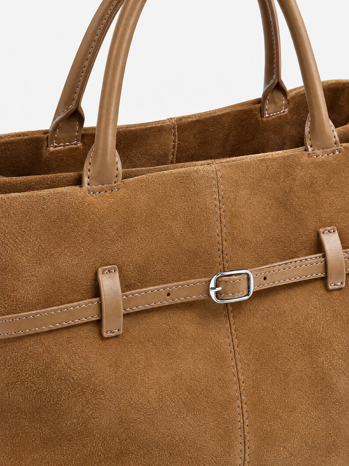 Close-up of the Khaki suede leather tote bag with stitched handles, a textured finish, and an adjustable front strap with buckle.