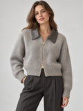 Model wearing a Gray cropped knit cardigan with a contrasting lapel collar and front zipper in a studio view.