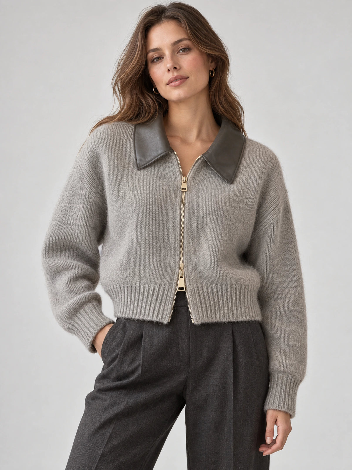 Model wearing a Gray cropped knit cardigan with a contrasting lapel collar and front zipper in a studio view.
