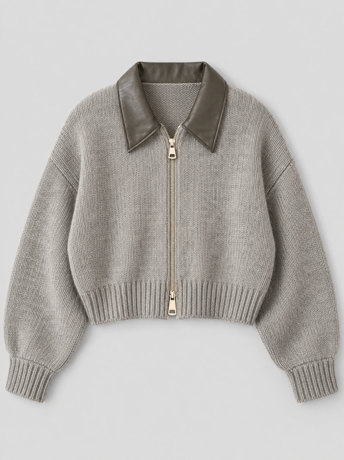 Gray thick knitted cropped cardigan laid flat, featuring a wide lapel collar, front zipper, and ribbed cuffs and hem.
