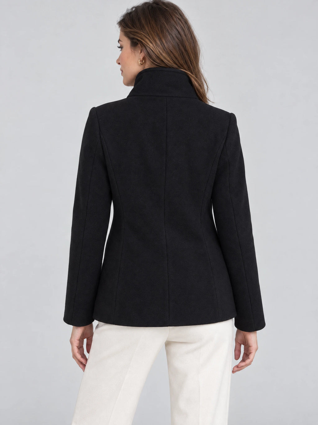 Back view of a model wearing a Black womens turtleneck coat with a high collar and contoured back seams.