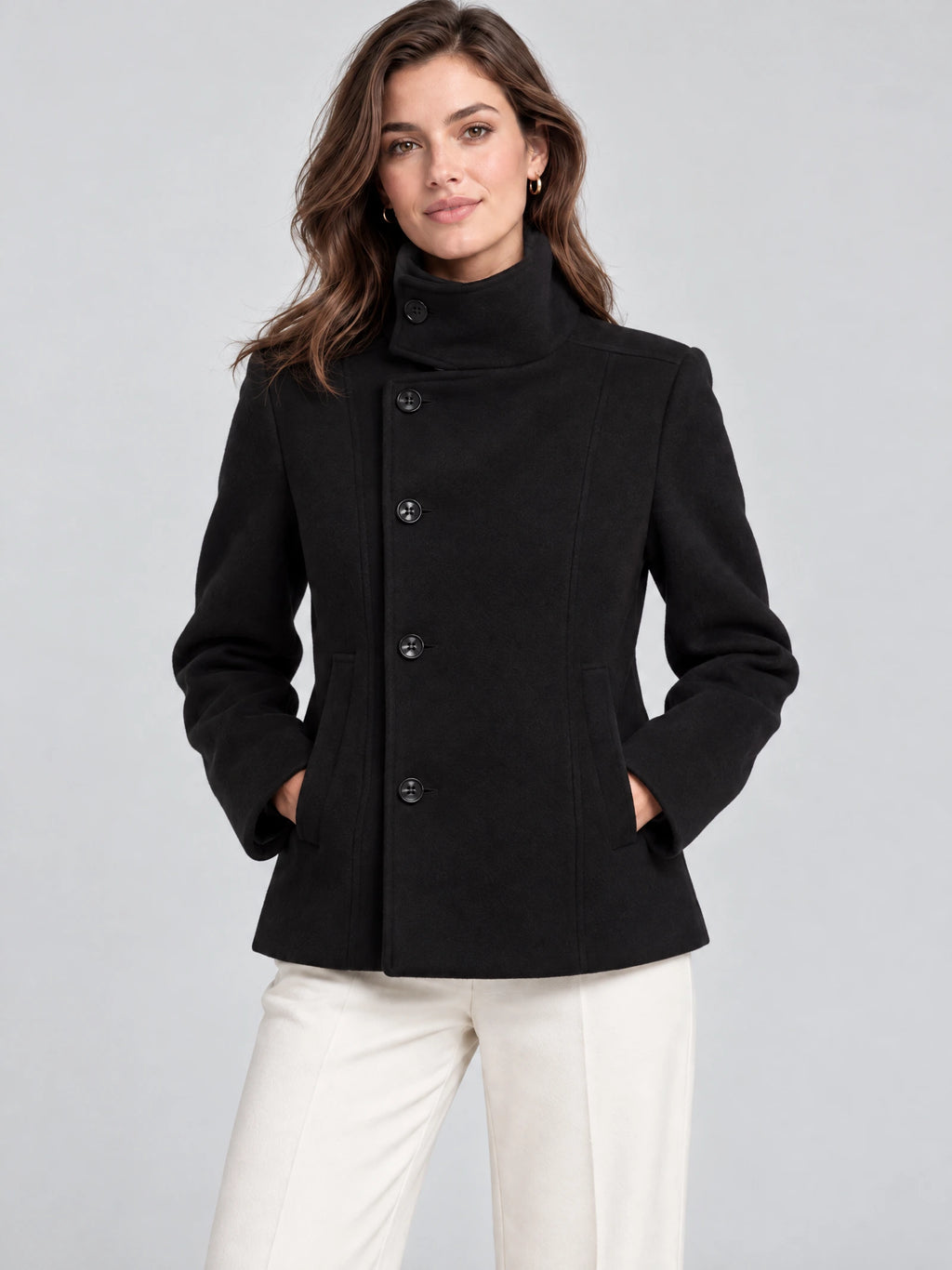Front studio view of a model wearing a Black womens turtleneck coat with button closure and front pockets.