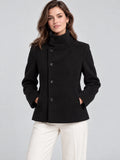 Front studio view of a model wearing a Black womens turtleneck coat with button closure and front pockets.