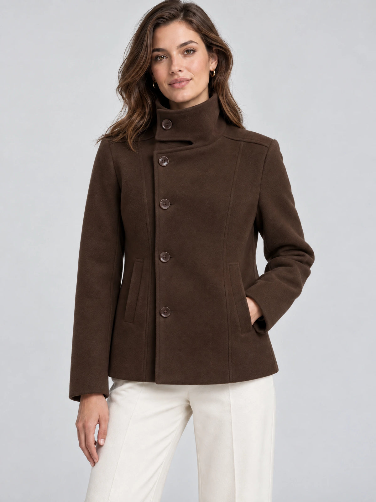 Front studio view of a model wearing a Brown womens turtleneck coat with button closure, stand collar, and angled pockets.