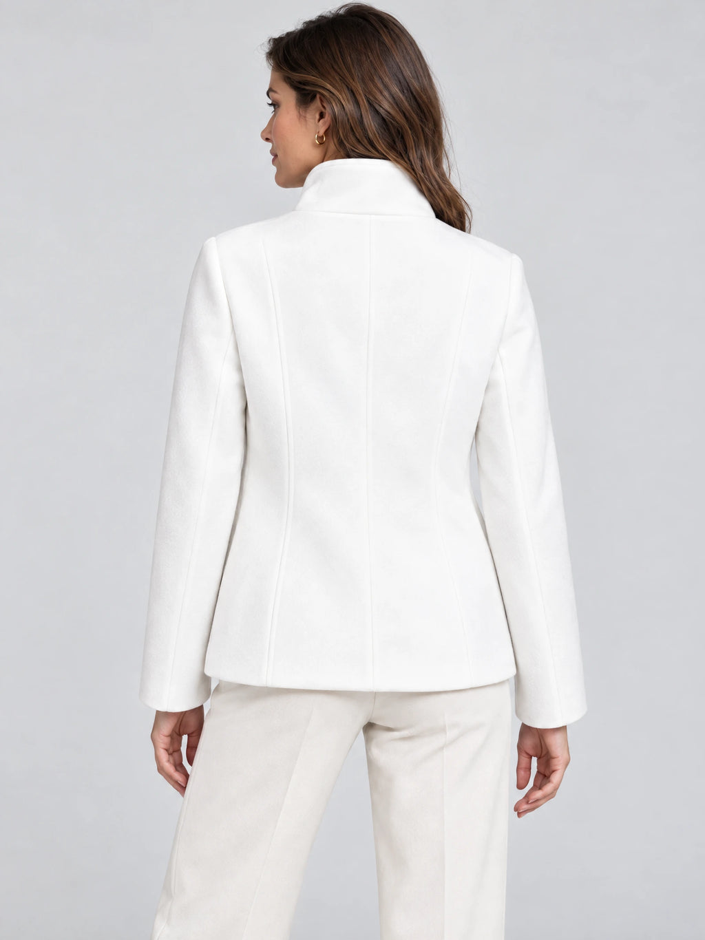 Back view of a model wearing a White womens turtleneck coat with a high collar and tailored back seams.
