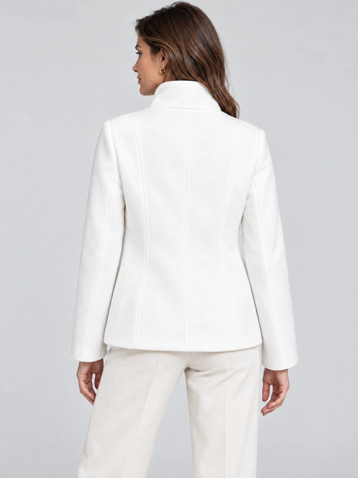 Back view of a model wearing a White womens turtleneck coat with a high collar and tailored back seams.