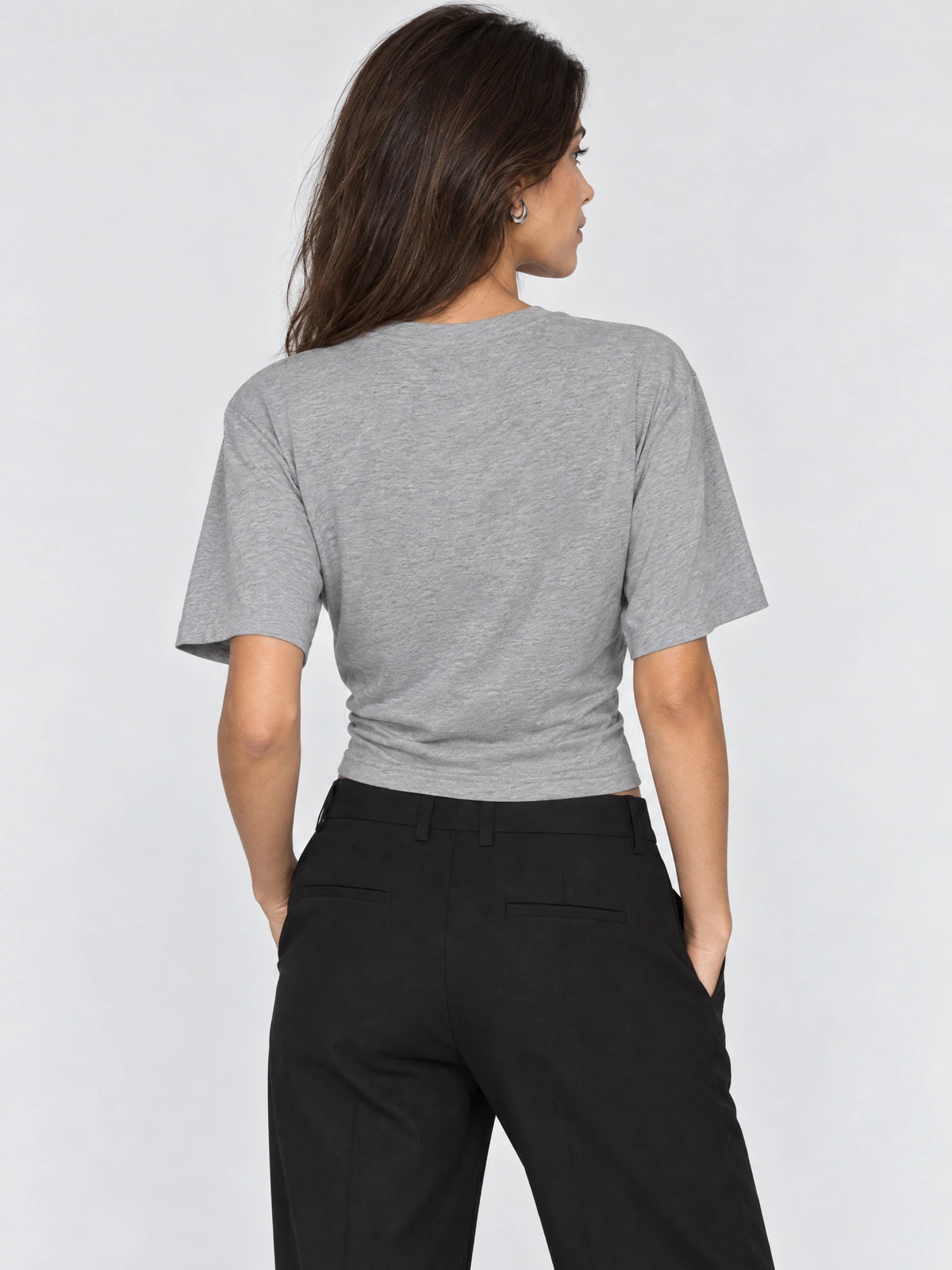 Back view of a model wearing a Gray cotton Waist Short Top with short sleeves and a fitted waist.