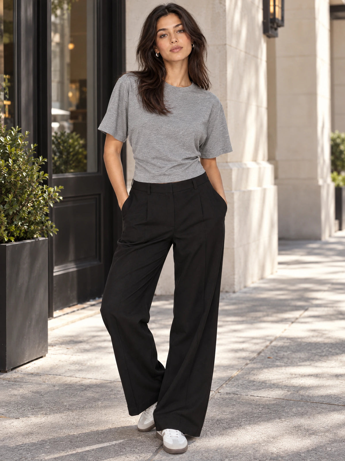 Model wears a Gray cotton Waist Short Top with a crew neckline while standing outside a building.