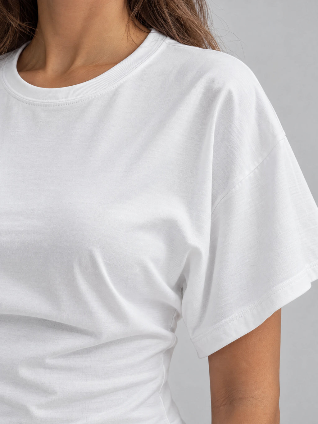 Close-up of the White cotton Waist Short Top showing its ribbed crew neckline, soft fabric, and wide short sleeve.
