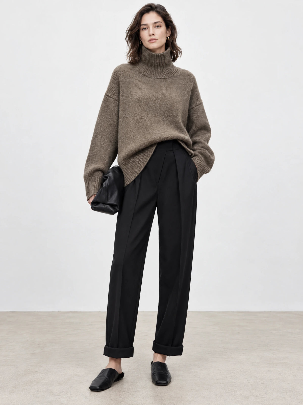 Model wearing a Brown turtleneck sweater with ribbed trim in a front studio view.