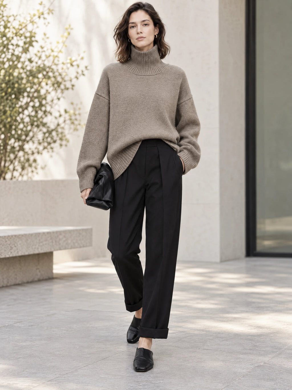 Model walking outdoors in a Khaki turtleneck sweater with ribbed collar, cuffs, and hem.