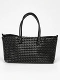 Black woven shoulder bag with braided texture and dual top handles, shown against a white studio background.