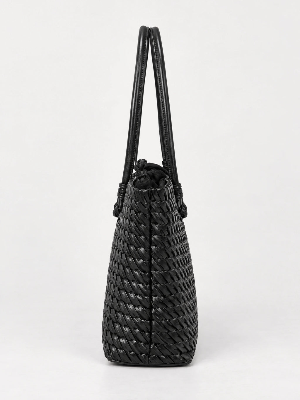 Black woven shoulder bag shown from the side, with a textured woven body, drawstring top, and long double handles.