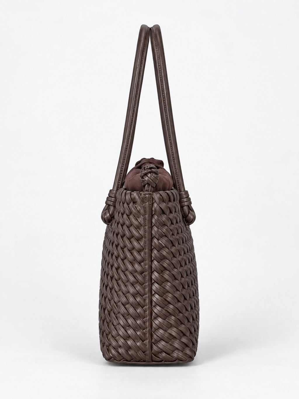 Side view of a Brown woven shoulder bag with braided texture, knotted top detail, and long double handles.
